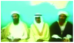 Image of Osama Bin Laden speaking on camera with 2 other men.